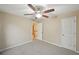 Bedroom with ceiling fan, a doorway, and a closet door and neutral colored walls and carpeting at 12947 Dunand Blvd, Hampton, GA 30228