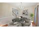 A beautifully staged dining room featuring neutral tones, modern decor, and natural light at 12947 Dunand Blvd, Hampton, GA 30228