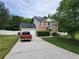 Two-story brick home featuring solar panels, a long driveway, and a well-maintained front yard at 12947 Dunand Blvd, Hampton, GA 30228