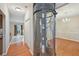 A unique home elevator sits next to a dining area with hardwood floors and a chandelier at 12947 Dunand Blvd, Hampton, GA 30228
