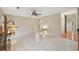 Open-concept living space featuring tile flooring, a fireplace, and a staircase leading to the upper level at 12947 Dunand Blvd, Hampton, GA 30228
