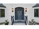 Close-up of the front door with elegant gray paint, brick surround, side windows and modern lighting at 2414 Cedar Wood Ct, Marietta, GA 30068