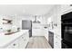 Bright, white kitchen with stainless steel appliances, an island, and ample counter space at 2414 Cedar Wood Ct, Marietta, GA 30068