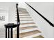 A staircase with black wrought iron railing and natural wood stairs at 2414 Cedar Wood Ct, Marietta, GA 30068