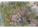 An aerial view reveals a home surrounded by verdant trees near a winding road at 2796 County Line Nw Rd, Acworth, GA 30101