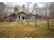 A house with a fenced in backyard and views of the surrounding trees at 2796 County Line Nw Rd, Acworth, GA 30101