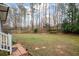 A spacious fenced in backyard with a stone walkway leading to a brick patio at 2796 County Line Nw Rd, Acworth, GA 30101