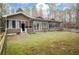 A house with a fenced in backyard and views of the surrounding trees at 2796 County Line Nw Rd, Acworth, GA 30101