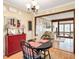 Charming dining area with wood floors, a red buffet, and an open view of the living space at 2796 County Line Nw Rd, Acworth, GA 30101