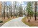 Long driveway leading to a charming home surrounded by mature trees at 2796 County Line Nw Rd, Acworth, GA 30101