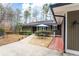 View of front entrance featuring outdoor table seating with umbrella and a well-manicured lawn at 2796 County Line Nw Rd, Acworth, GA 30101