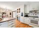 Well-appointed kitchen with white cabinets, modern appliances, and a view into the dining area at 2796 County Line Nw Rd, Acworth, GA 30101