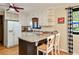 Well-lit kitchen features white cabinets, a breakfast bar, and a view to the backyard at 2796 County Line Nw Rd, Acworth, GA 30101