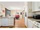 Bright kitchen featuring white cabinets, a breakfast bar, and stainless steel appliances at 2796 County Line Nw Rd, Acworth, GA 30101