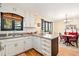 Open kitchen layout with an island, white cabinets, and a view into the dining area at 2796 County Line Nw Rd, Acworth, GA 30101