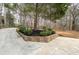 Landscaped yard with mulch beds, retaining wall and mature trees at 2796 County Line Nw Rd, Acworth, GA 30101