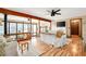 Bright and airy living room featuring wood floors, a fireplace, and large windows at 2796 County Line Nw Rd, Acworth, GA 30101