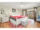 Bright main bedroom with a ceiling fan, hardwood floors, and a door that leads to the outdoors at 2796 County Line Nw Rd, Acworth, GA 30101