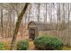 Wood outbuilding with double doors nestled between mature trees and lush greenery at 2796 County Line Nw Rd, Acworth, GA 30101