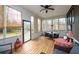 Cozy screened-in porch featuring wood flooring, outdoor seating, and views of the surrounding landscape at 2796 County Line Nw Rd, Acworth, GA 30101