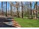 Backyard featuring a grassy area and a winding gravel path perfect for outdoor enjoyment at 2818 Thornbriar Rd, Atlanta, GA 30340