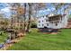 Beautiful backyard with green lawn, stream, fire pit, and a covered patio, perfect for outdoor living at 2818 Thornbriar Rd, Atlanta, GA 30340
