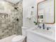 Bathroom with tiled shower, modern fixtures, and a vanity with a white countertop at 2818 Thornbriar Rd, Atlanta, GA 30340