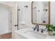 Bathroom vanity featuring a decorative mirror, black fixtures, and tile shower at 2818 Thornbriar Rd, Atlanta, GA 30340