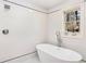 Bright bathroom featuring freestanding tub, chrome fixtures, white subway tile and natural light at 2818 Thornbriar Rd, Atlanta, GA 30340