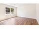 Bright bedroom with light hardwood floors and window with wooded view at 2818 Thornbriar Rd, Atlanta, GA 30340