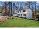 Angle view of a charming white two-story home with green lawn and an attached garage at 2818 Thornbriar Rd, Atlanta, GA 30340