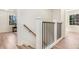 Hallway with light hardwood floors, wooden railing and views of a windowed room at 2818 Thornbriar Rd, Atlanta, GA 30340