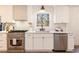 Bright kitchen with white cabinets, stainless steel oven and a view to the outside at 2818 Thornbriar Rd, Atlanta, GA 30340