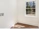 Bright laundry room with wood-look floors, window, and washer/dryer hookups at 2818 Thornbriar Rd, Atlanta, GA 30340