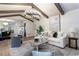 Bright living room features beamed ceilings, modern lighting, hardwood floors, and open concept design at 2818 Thornbriar Rd, Atlanta, GA 30340