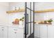 Pantry featuring white shiplap, open shelves and frosted door at 2818 Thornbriar Rd, Atlanta, GA 30340