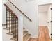 Carpeted stairway with wooden handrail and black metal balusters at 2818 Thornbriar Rd, Atlanta, GA 30340