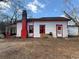 Exterior shot of home featuring a red painted chimney, small white door and an enclosed back porch at 633 Langston Sw Dr, Atlanta, GA 30315