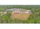 Aerial view of a large school building surrounded by athletic fields, parking lots, and lush trees at 8980 Country Club Dr, Douglasville, GA 30134