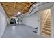 Unfinished basement with an unfinished ceiling and a door leading to the stairs at 8980 Country Club Dr, Douglasville, GA 30134