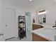 Bright bathroom featuring dual vanities and shelving for ample storage at 8980 Country Club Dr, Douglasville, GA 30134