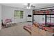 Spacious bedroom featuring a bunk bed, ceiling fan, and a bright atmosphere at 8980 Country Club Dr, Douglasville, GA 30134