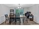 Cozy dining room featuring a wooden table with seating for six, a chandelier, and backyard view at 8980 Country Club Dr, Douglasville, GA 30134