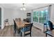 Elegant dining room with large window, chandelier, and table for six, perfect for gatherings at 8980 Country Club Dr, Douglasville, GA 30134