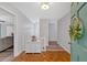 Bright foyer with stylish light fixture, coat closet, and hardwood flooring at 8980 Country Club Dr, Douglasville, GA 30134