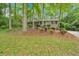 Inviting front exterior of a home with beautiful landscaping and mature trees at 8980 Country Club Dr, Douglasville, GA 30134