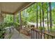 Covered front porch with outdoor seating area offers a relaxing space to enjoy the neighborhood views at 8980 Country Club Dr, Douglasville, GA 30134