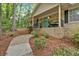 Home exterior showing a quaint front porch with a seating area at 8980 Country Club Dr, Douglasville, GA 30134