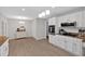 Bright kitchen boasts white cabinetry, stainless steel appliances, granite countertops, and hardwood floors at 8980 Country Club Dr, Douglasville, GA 30134