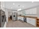 Bright kitchen featuring stainless steel appliances, white cabinets, granite countertops, and sleek lighting fixtures at 8980 Country Club Dr, Douglasville, GA 30134